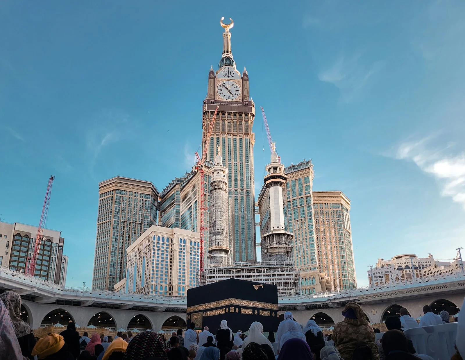 a group of people standing in front of a tall building a group of people standing in front of a tall building