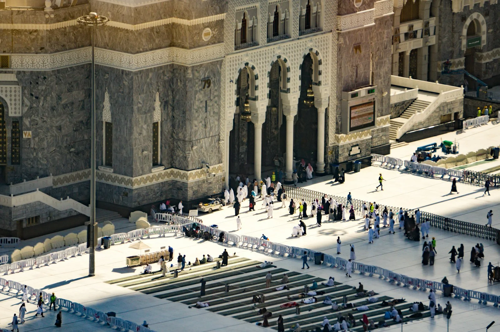 Pilgrims gather in a large courtyard before a grand mosque Pilgrims gather in a large courtyard before a grand mosque
