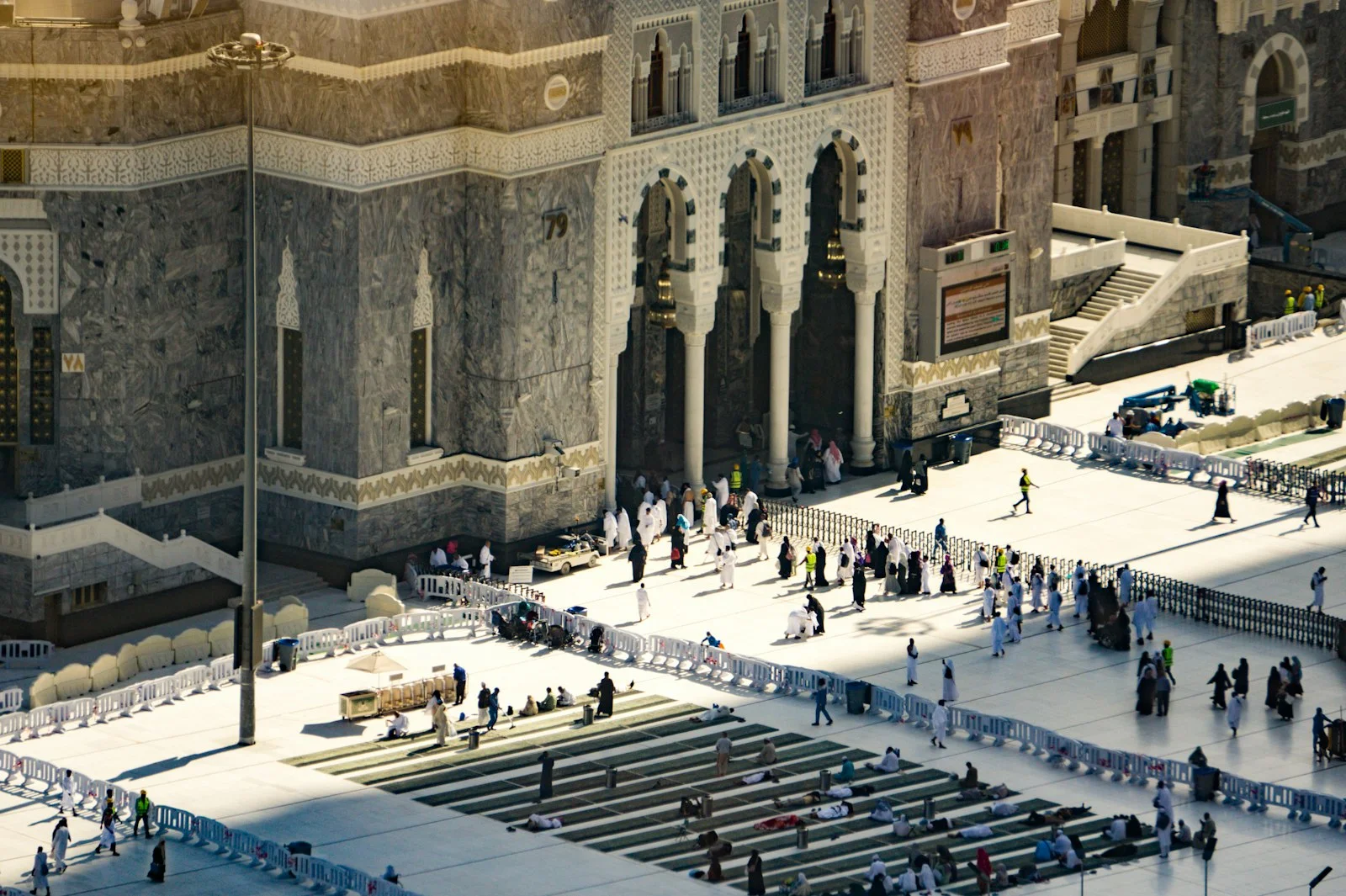 Pilgrims gather in a large courtyard before a grand mosque. Pilgrims gather in a large courtyard before a grand mosque.