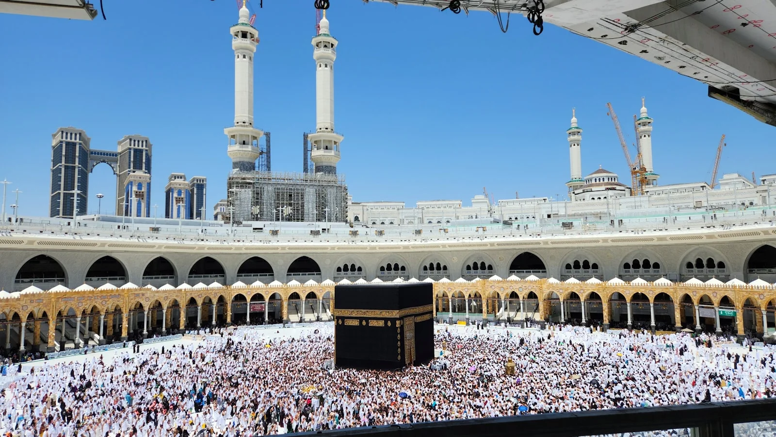 Pilgrims surround the kaaba at the grand mosque in mecca Pilgrims surround the kaaba at the grand mosque in mecca