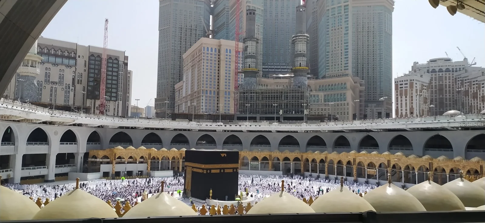 a group of people standing around a large building a group of people standing around a large building
