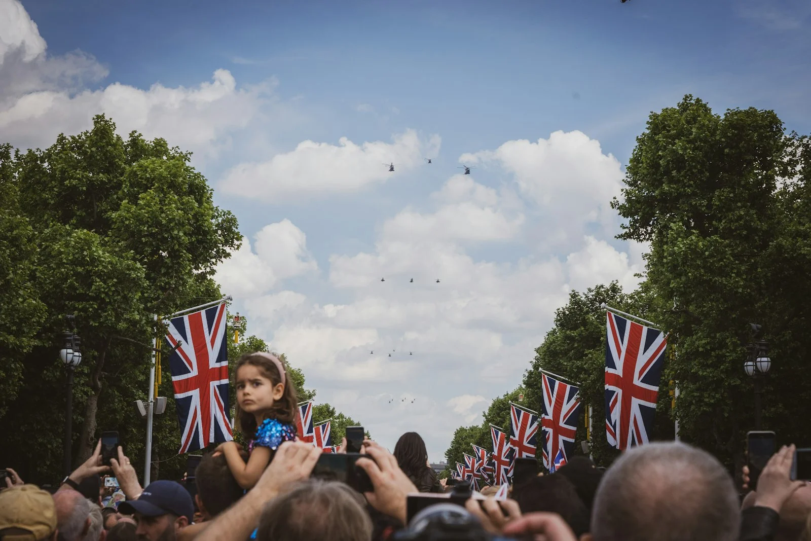a crowd of people holding flags and taking pictures a crowd of people holding flags and taking pictures